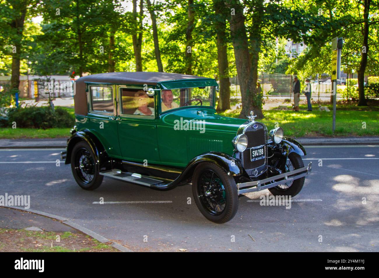 1928, 1920s, twenties pre-war Green Ford Sedan.  Ford Model A Phaeton; Cars arriving at the annual Stanley Park Classic Car Show. Stanley Park classics Motor Show is hosted by Blackpool Vintage Vehicle Preservation Group, UK. Stock Photo