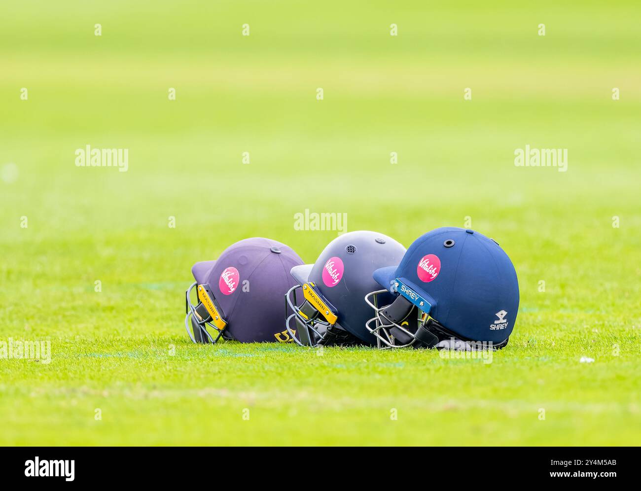 Cricket helmets left on the ground during a County Championship match between Derbyshire and Middlesex Stock Photo