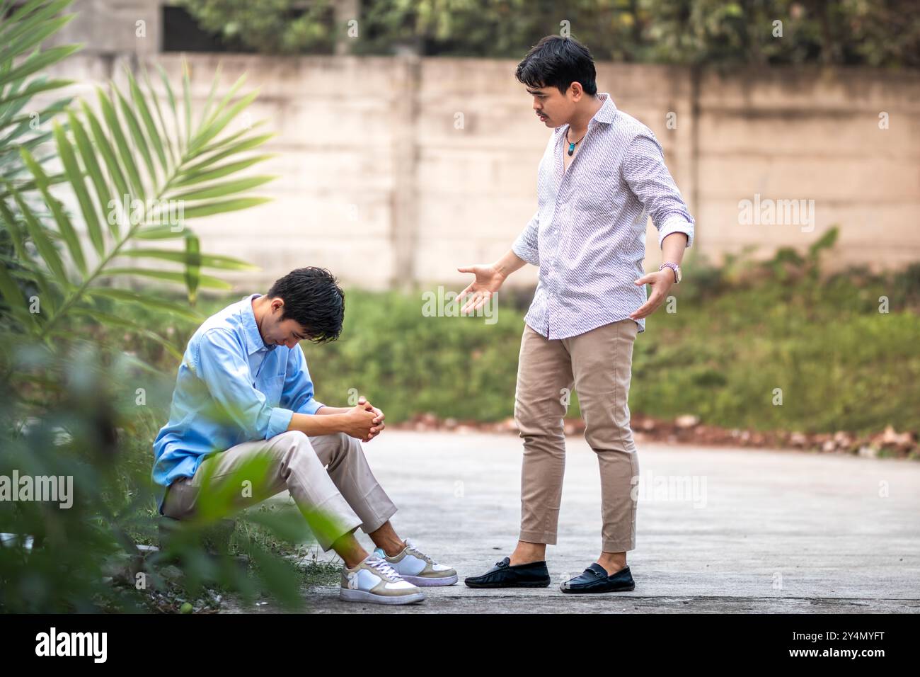 An employee being scolded by his boss. A man scolding and yelling at another man for making a mistake. Stock Photo