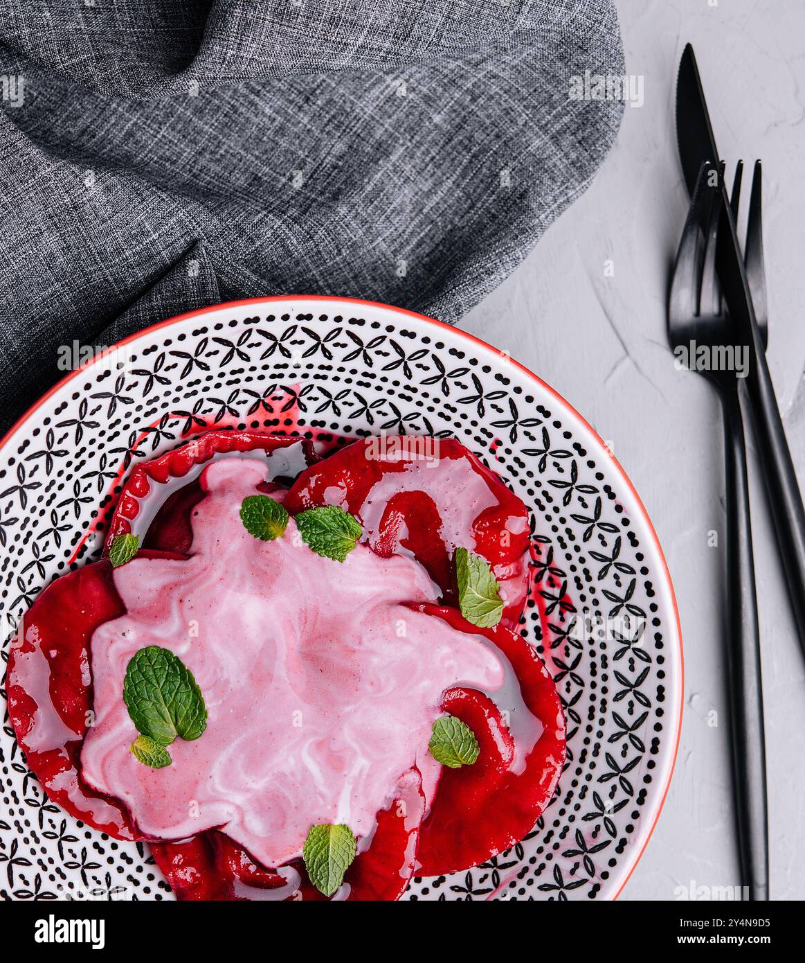 Vegan red ravioli with beetroot on a plate in cream sauce Stock Photo ...