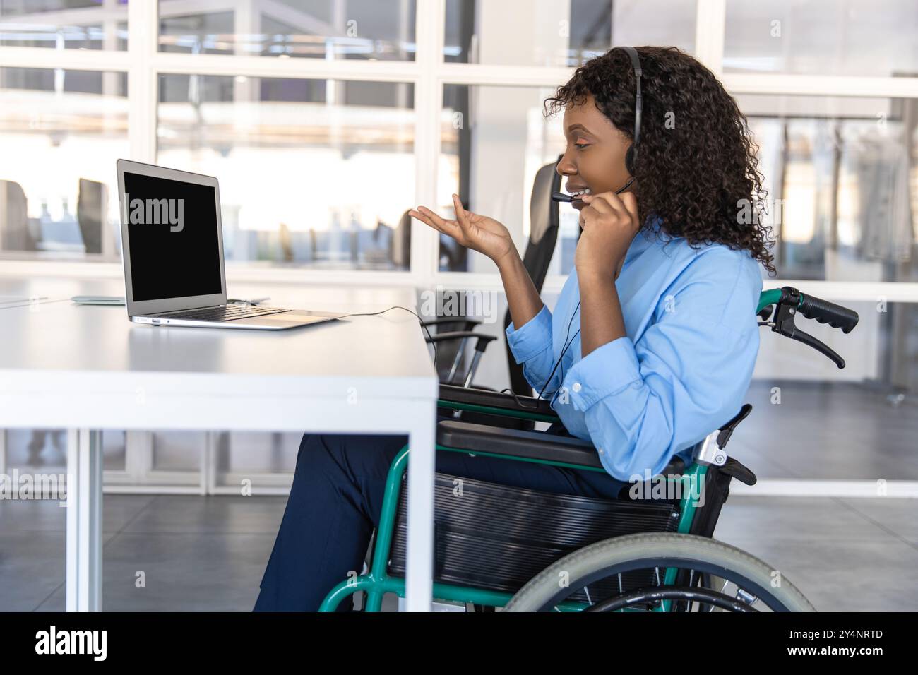 Disabled woman talking with clients over the phone from her office ...