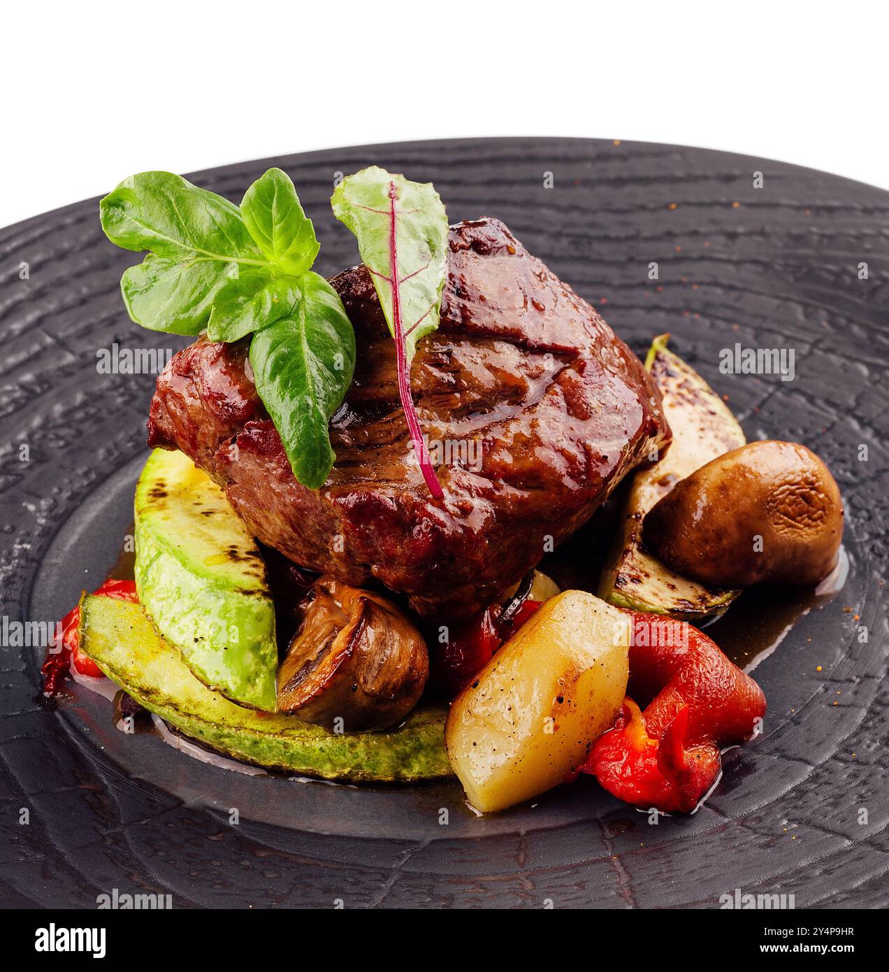 gourmet appetizing roasted beef steak with potato wedges and other vegetables Stock Photo