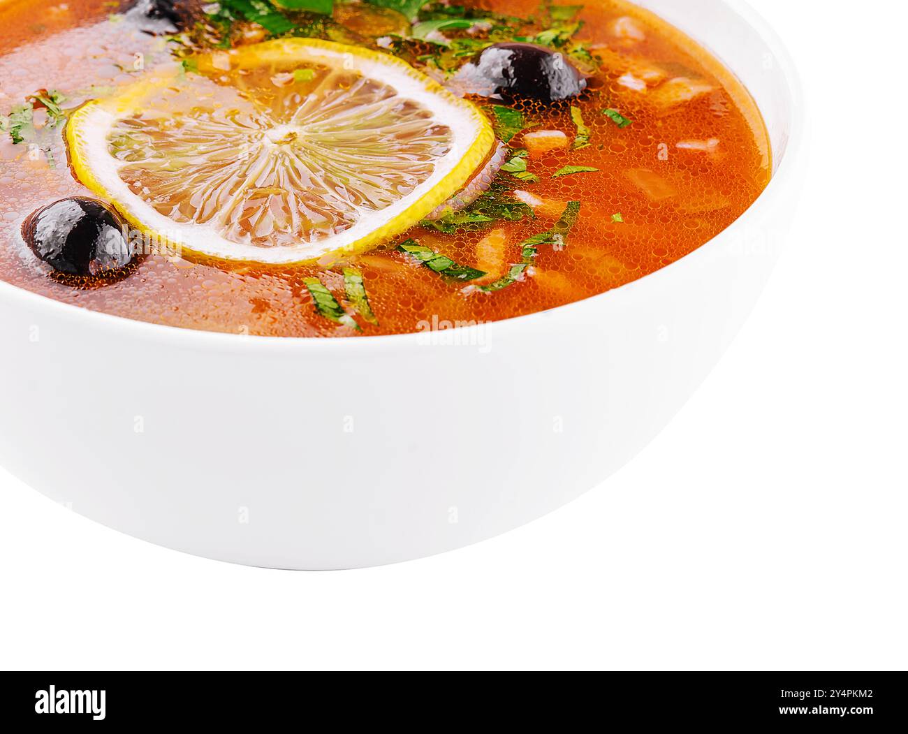 meat soup Solyanka in bowl on white Stock Photo