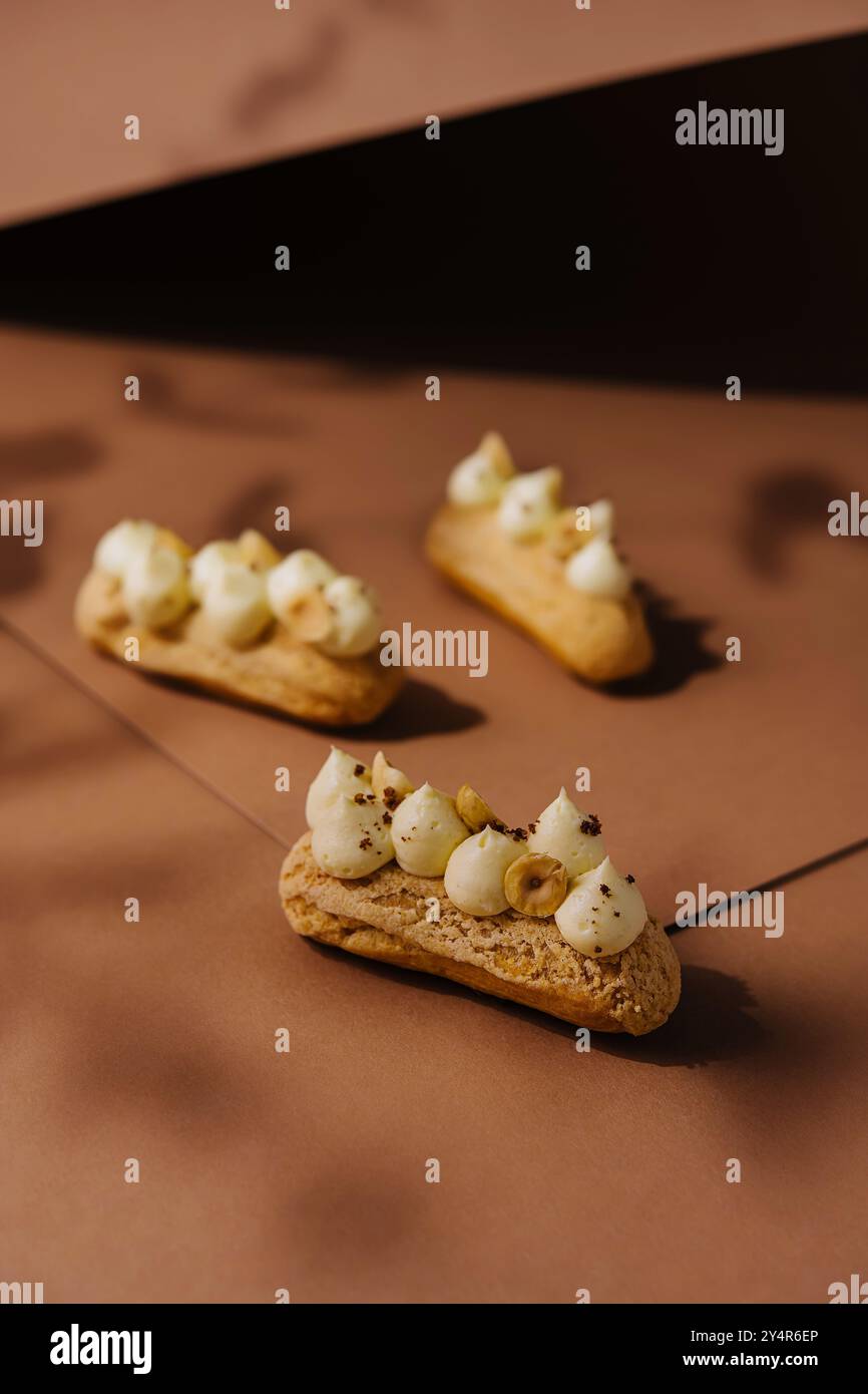 eclairs with whipped cream and hazelnuts Stock Photo