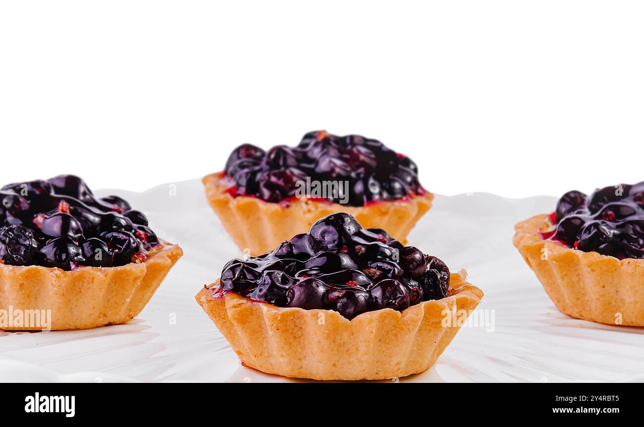 Small cakes with currant on white big plate Stock Photo