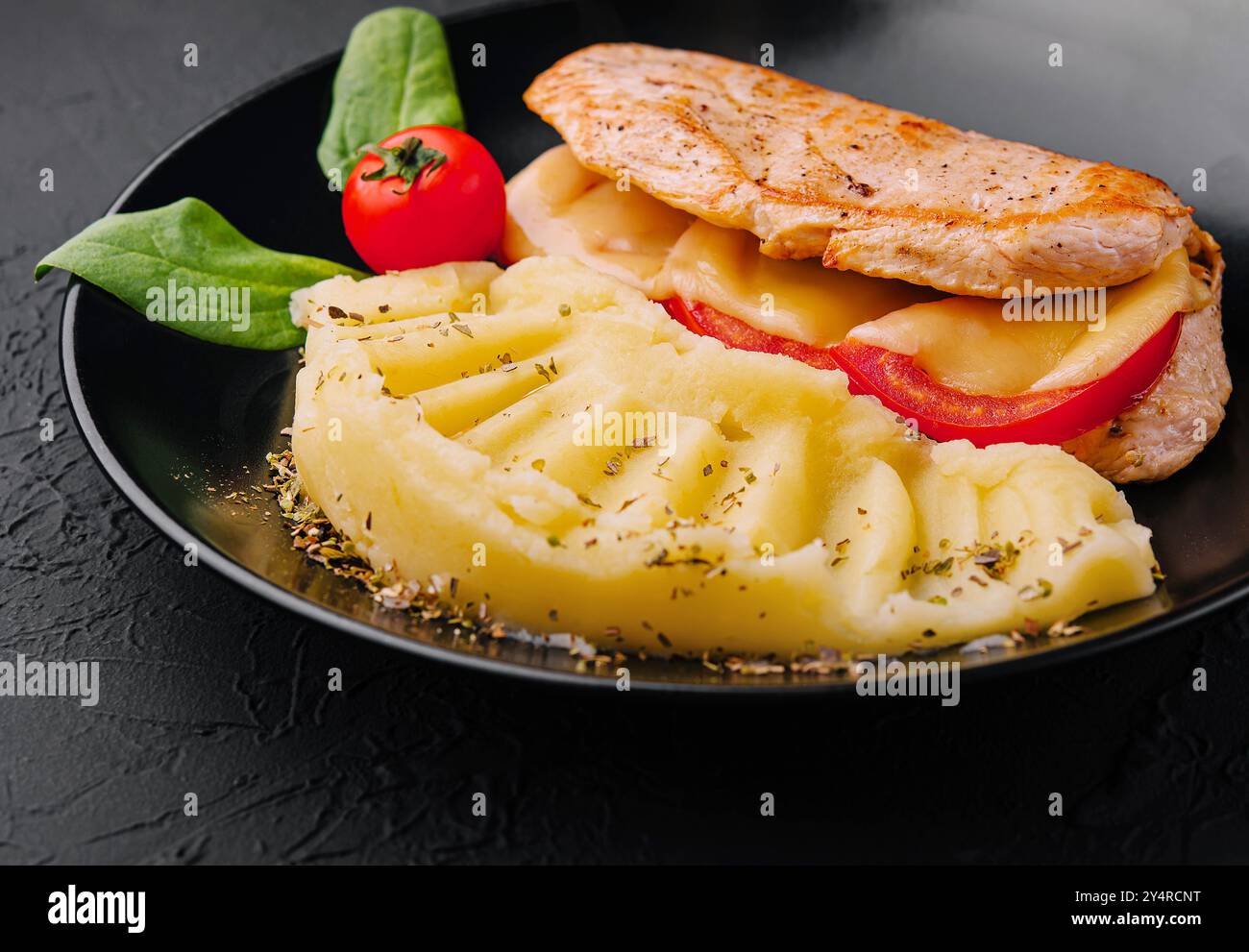 Baked chicken fillet with cheese and mashed potatoes Stock Photo - Alamy