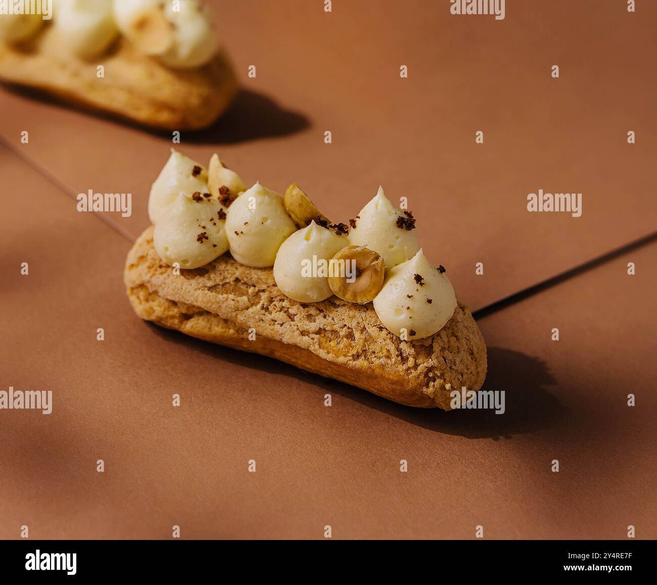 eclairs with whipped cream and hazelnuts Stock Photo