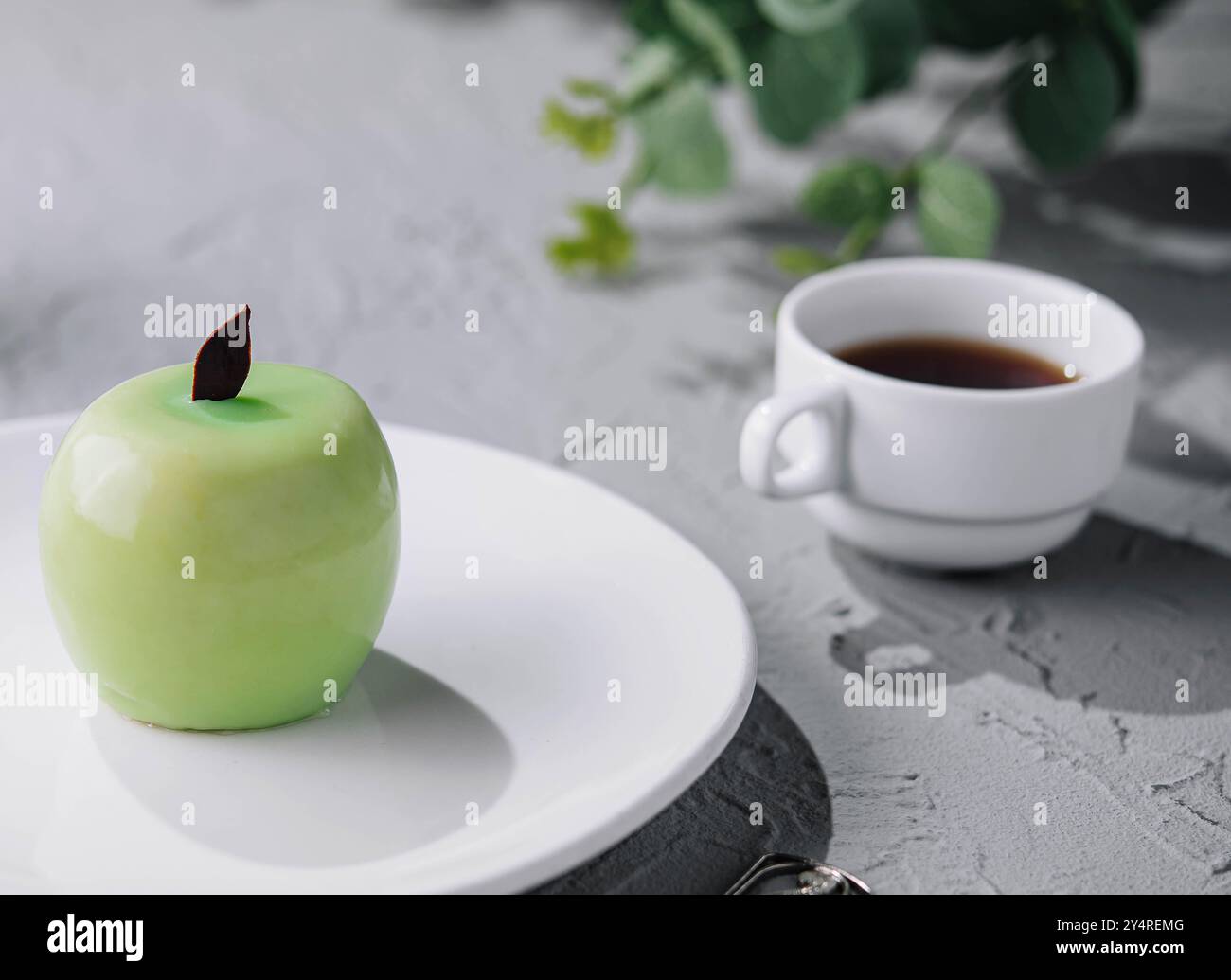 apple shaped mousse cake and tea Stock Photo