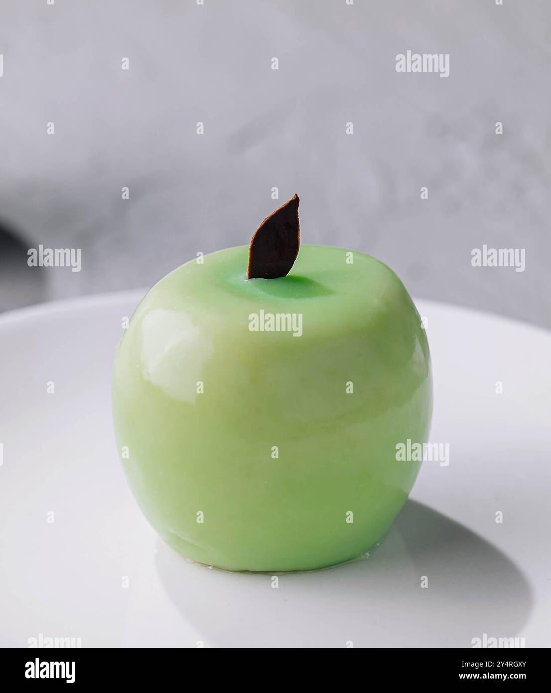 Green apple shaped mousse cake close up Stock Photo