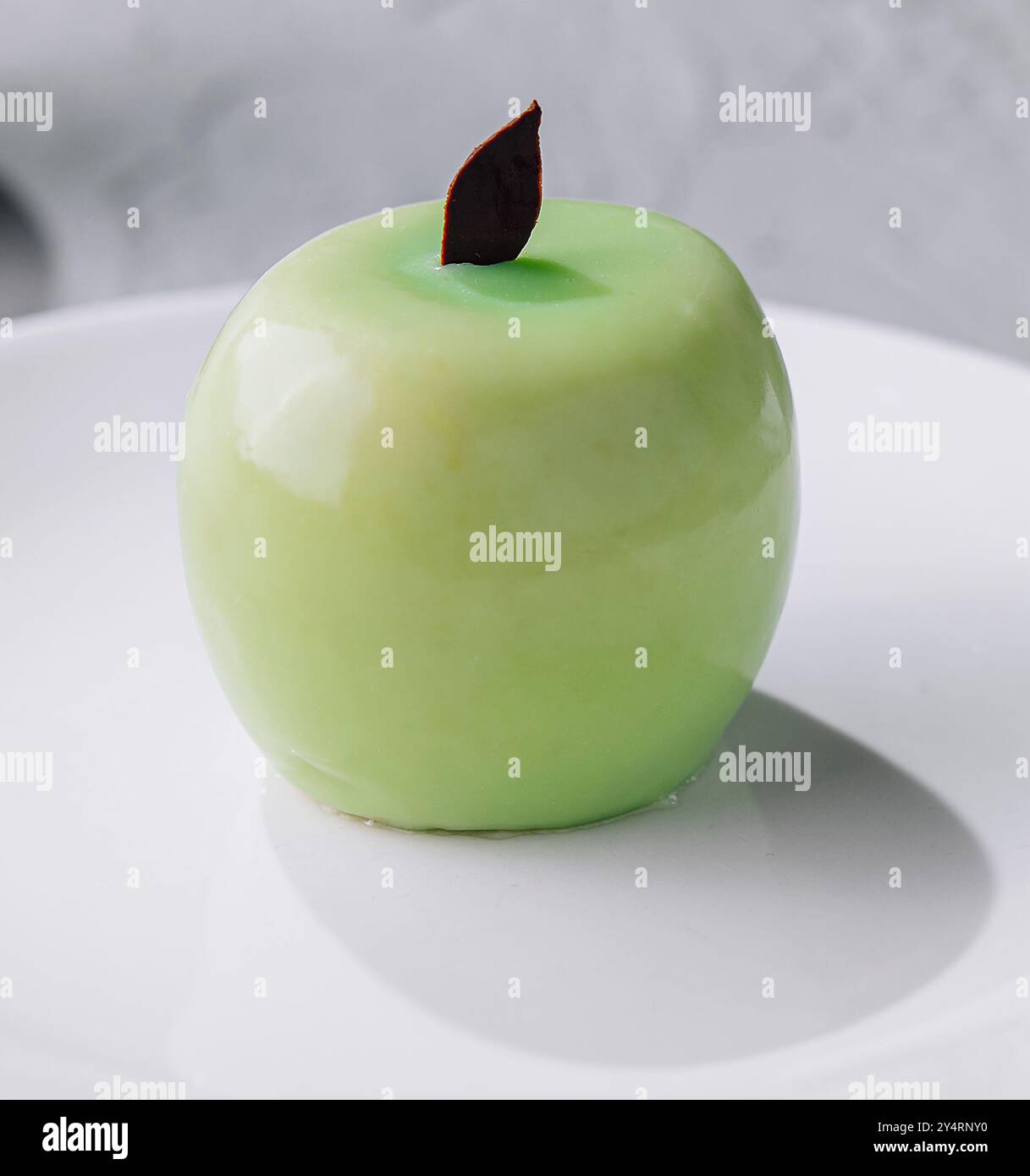 apple shaped mousse cake on plate Stock Photo