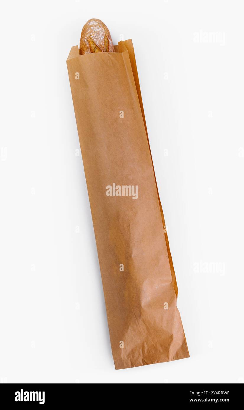 Top view of a crusty baguette peeking out from a brown paper bag ...