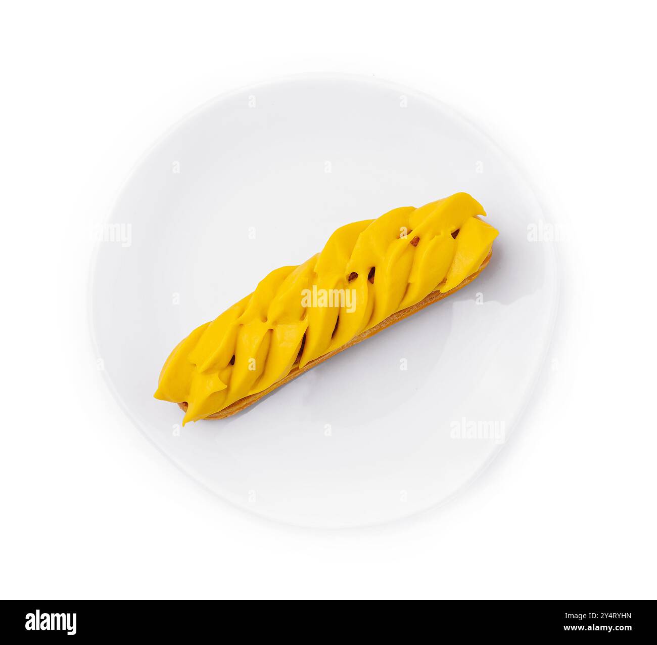 Vibrant mango eclair presented on a pure white circular plate, isolated ...