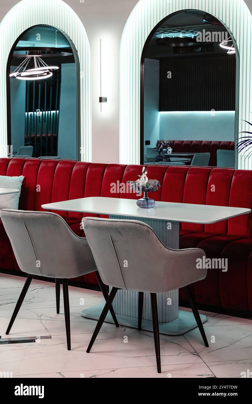 Elegant cafe interior showcasing a chic red velvet sofa, marble ...