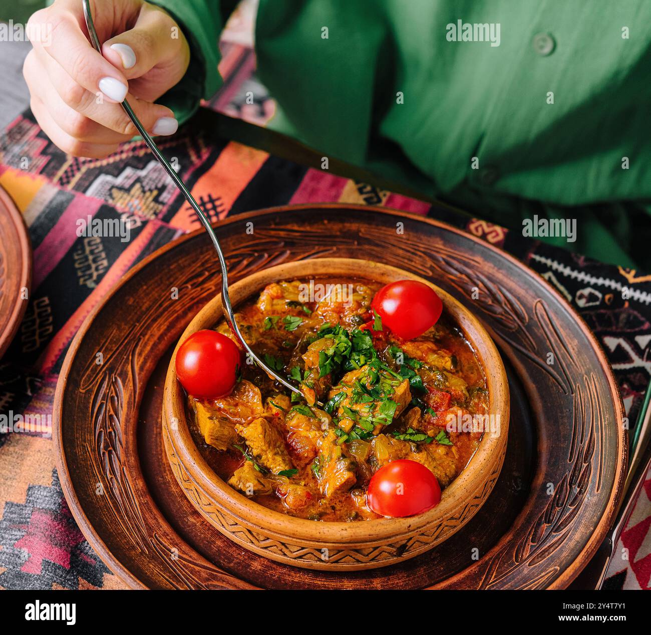 Patron savors a delicious stew in an ethnic restaurant setting Stock ...