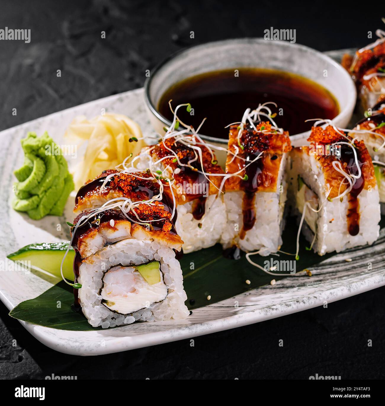 Gourmet sushi roll garnished with spicy mayo and sprouts hi-res stock ...