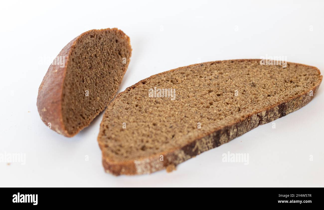 Close up shot of pieces of brown bread on white background Stock Photo ...