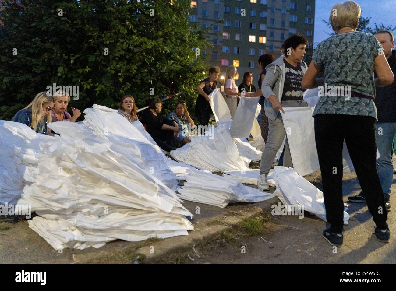 Olawa, Poland. 18th Sep, 2024. Women are opening packages of sandbags for flood protection. Olawa is preparing for a flood wave on the rivers caused by heavy rains in this part of Europe. For several days, powerful and destructive floods have been sweeping through southern Poland, devastating entire villages and towns. In Poland, 7 people have already died as a result of the floods, and the damages are immense. Many people have been left without homes, having lost their life's possessions. In response, a nationwide mobilization has begun in Poland, with not only the military but also civil Stock Photo