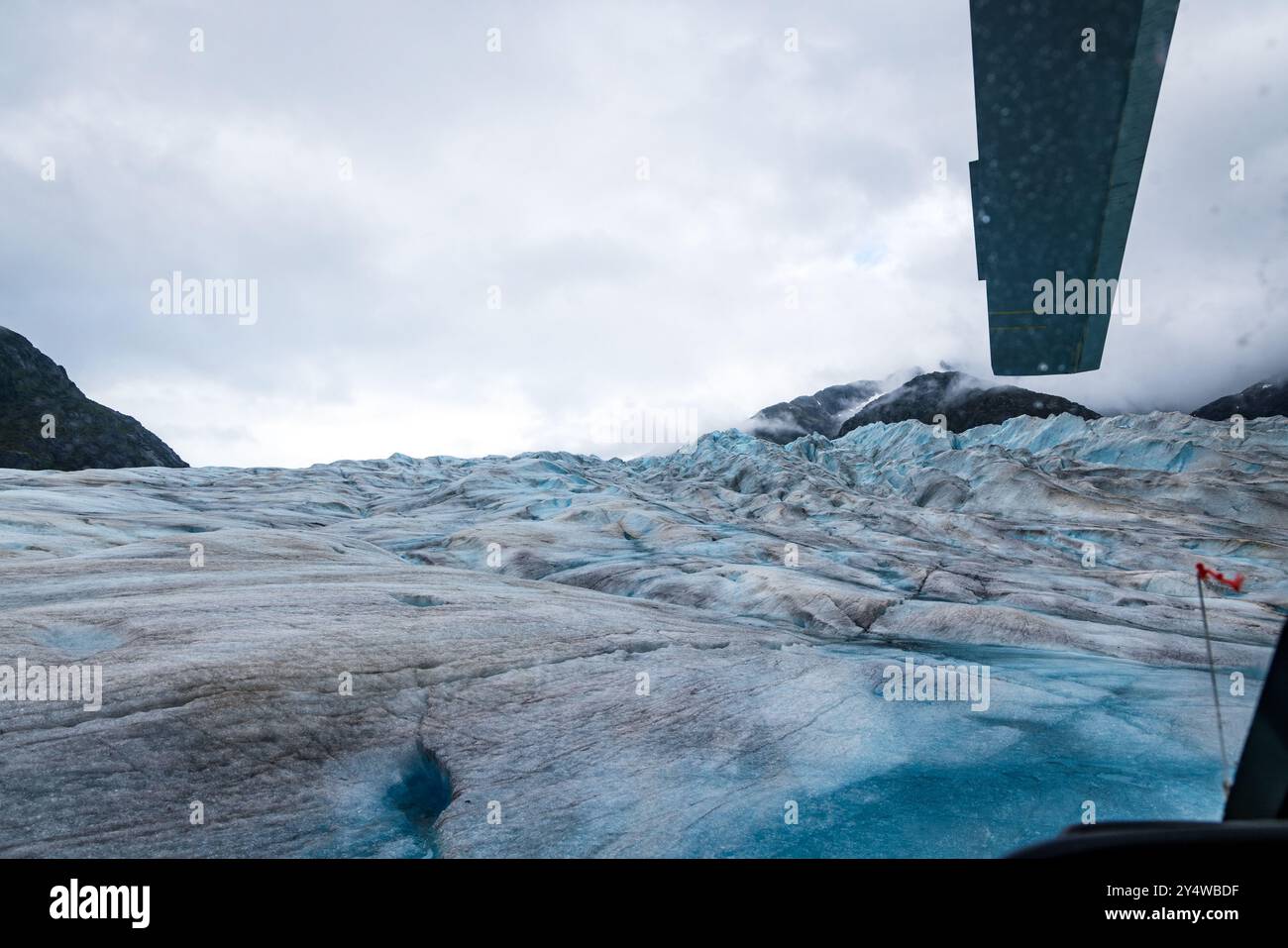 View of the Herbert Glacier in Juneau, Alaska from the cockpit of a helicopter Stock Photo