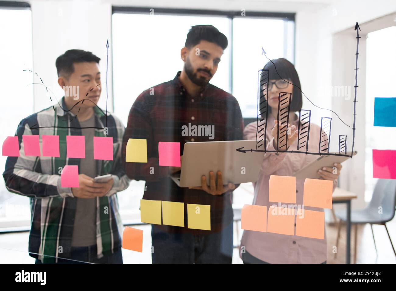 Business team brainstorming with sticky notes and charts Stock Photo ...