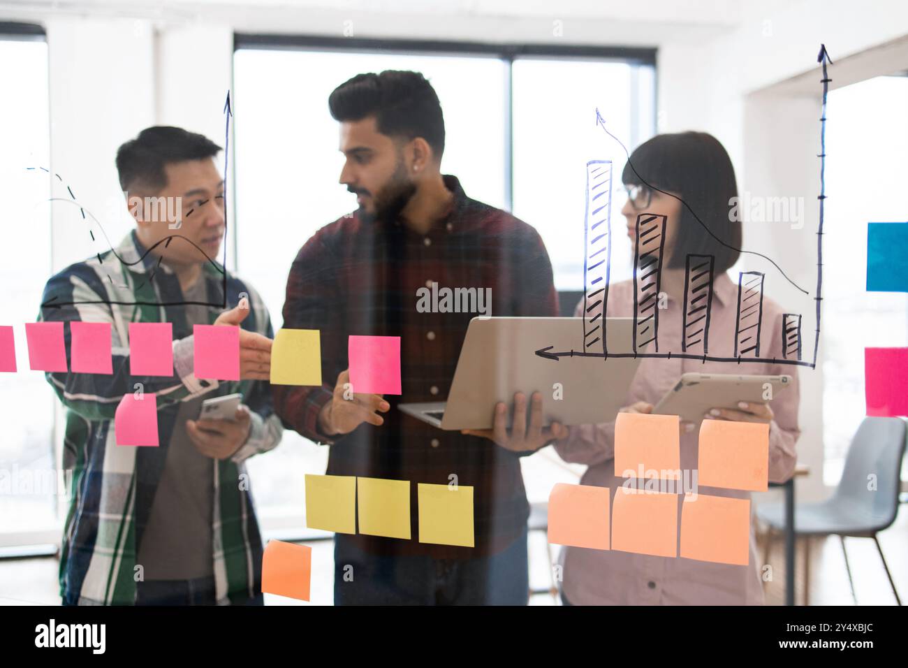 Business team brainstorming ideas with sticky notes and charts Stock ...