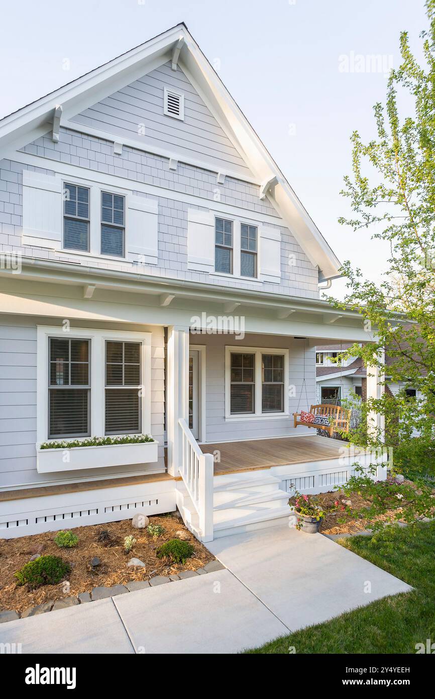 Front of cottage style house showing front porch and porch swing Stock ...