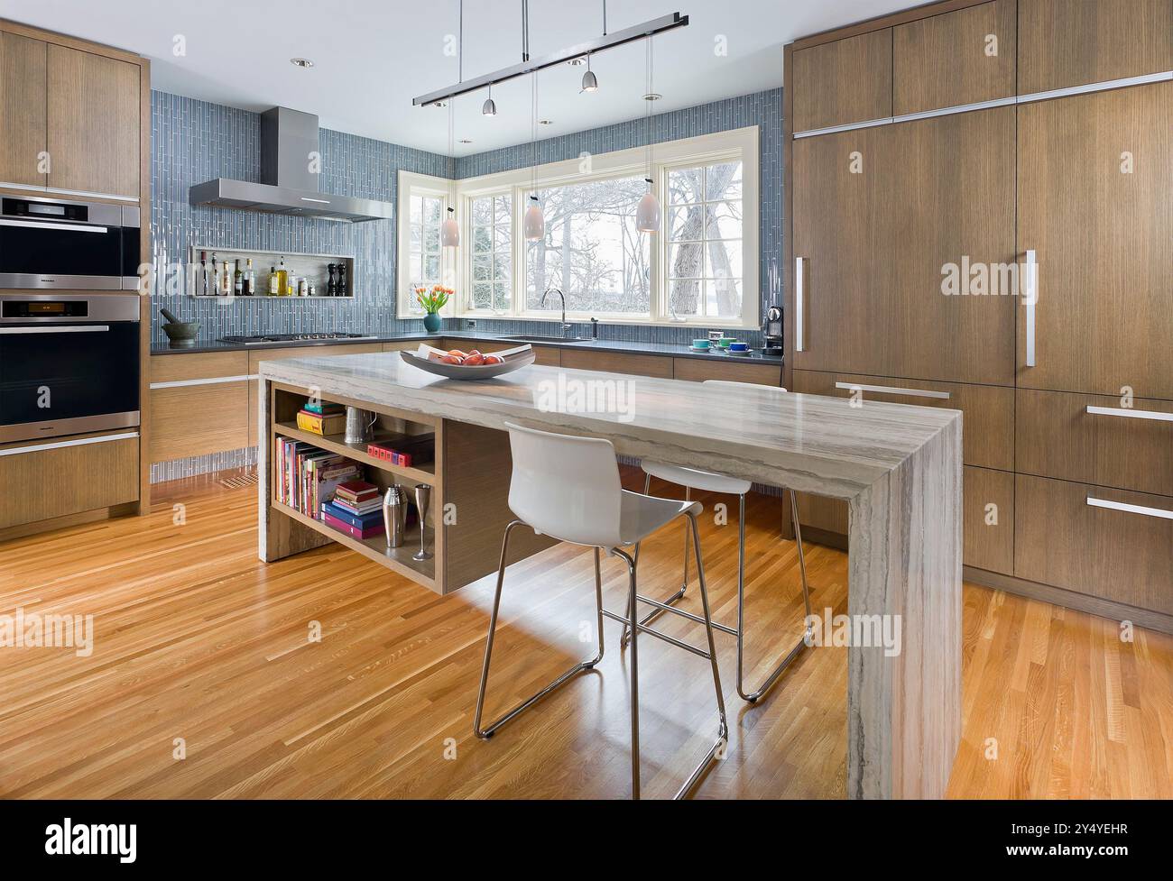 Modern kitchen with rift sawn white oak cabinets and large stone island ...