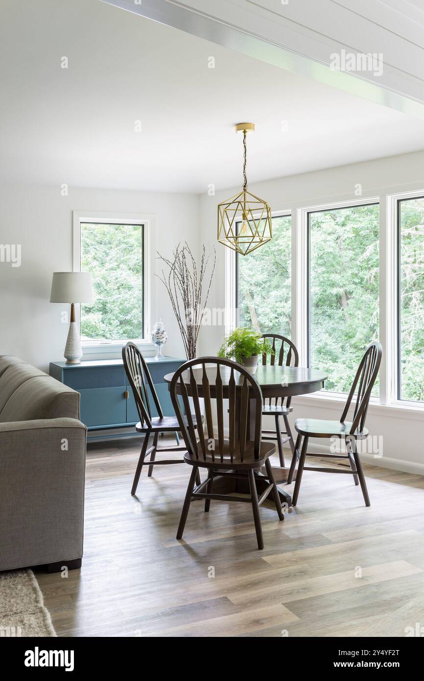 Small round dining table in corner of living space surrounded by ...