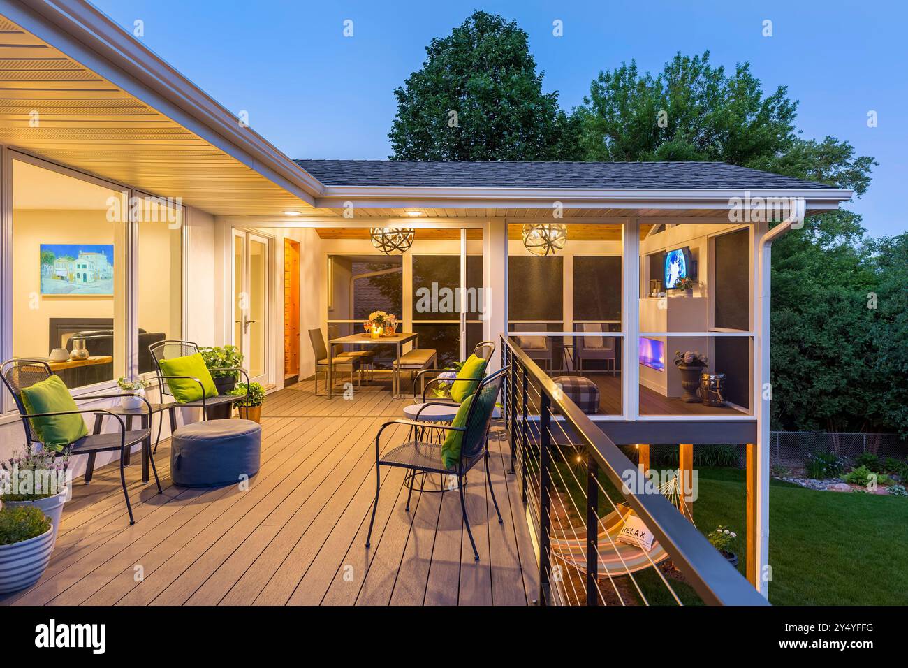 Upper level deck of house looking into three season screened porch with