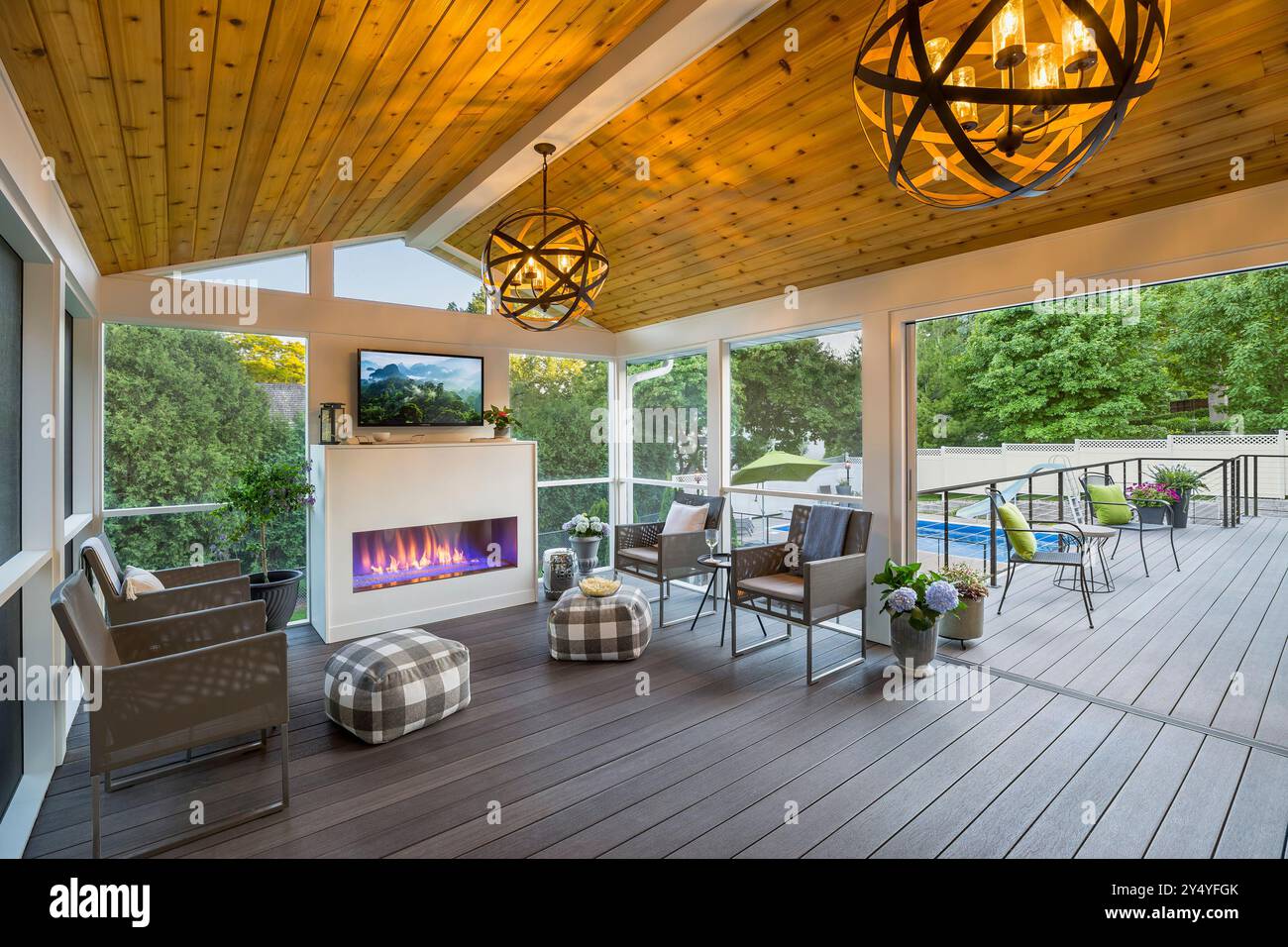 Screened 3 season porch with fireplace and view out to deck and
