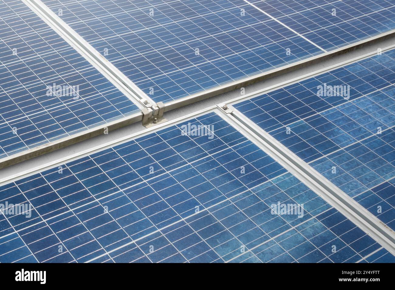 A solar panel or solar cell is shown in a close up. The panel is blue and has a grid pattern. Photovoltaic module. Alternative power source for saving Stock Photo
