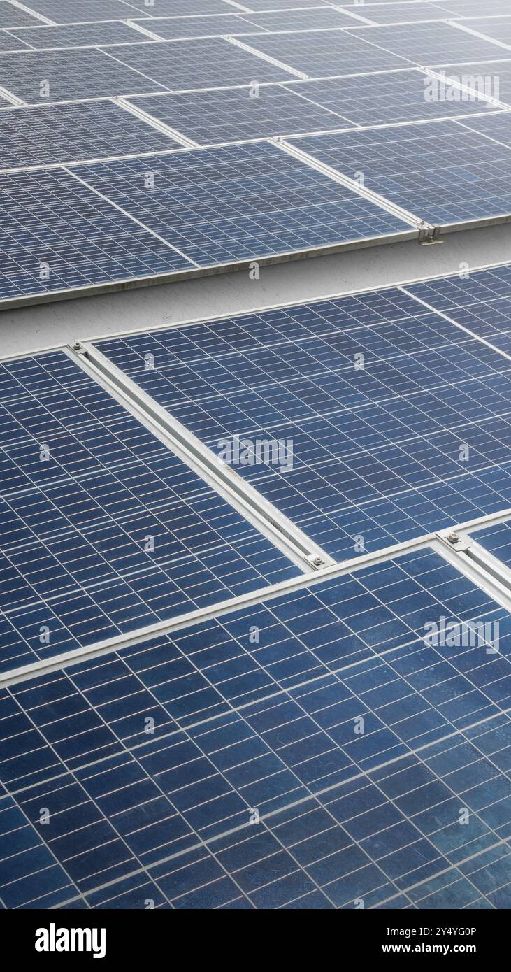 A solar panel or solar cell is shown in a close up. The panel is blue and has a grid pattern. Photovoltaic module. Alternative power source for saving Stock Photo