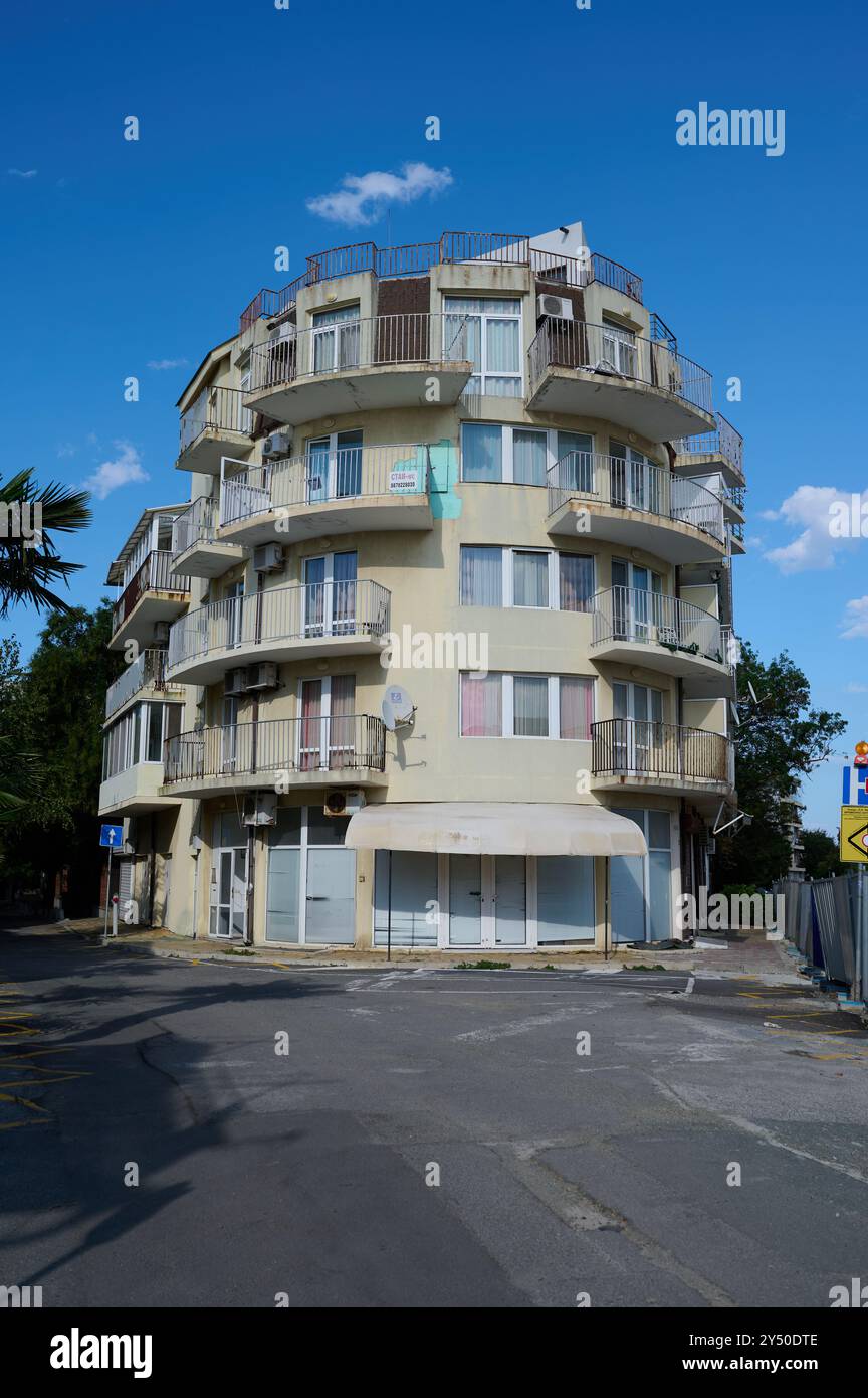 Unique curved modern building with balconies located on a bustling ...