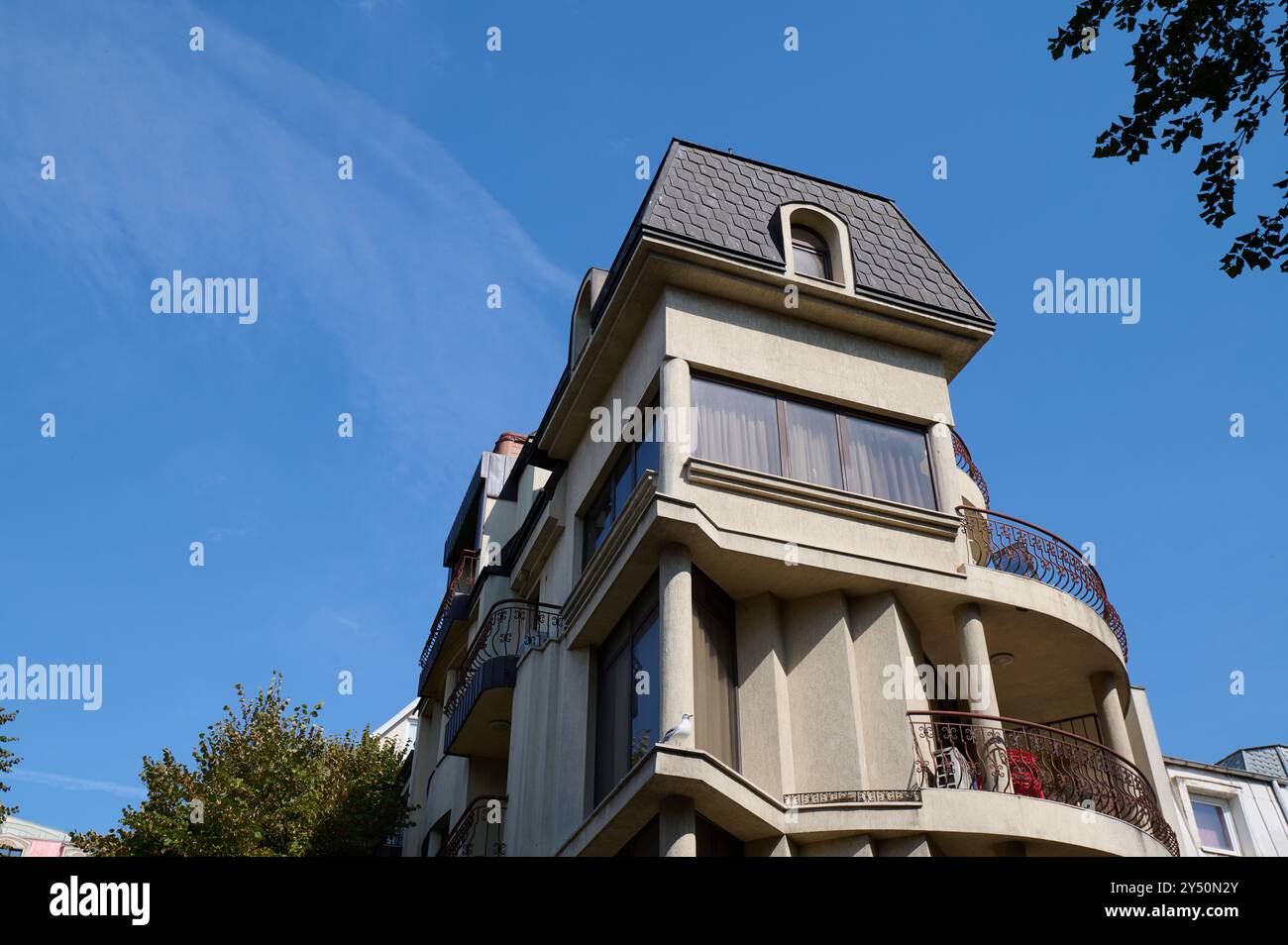 Unique architectural design of a modern building under a clear blue sky ...