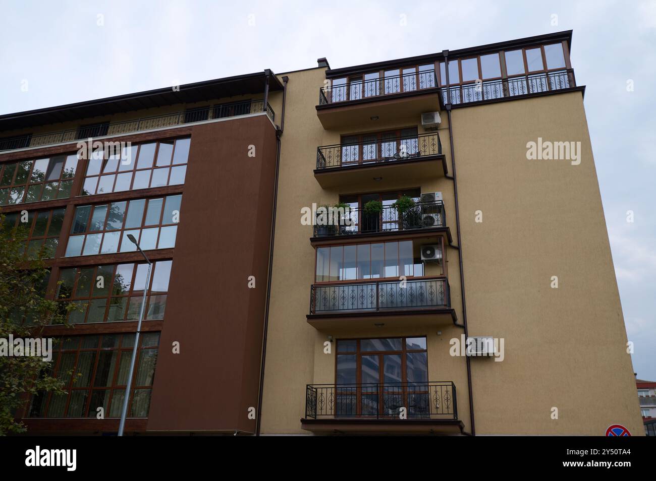 Stylish modern apartment building with large windows and balconies in ...