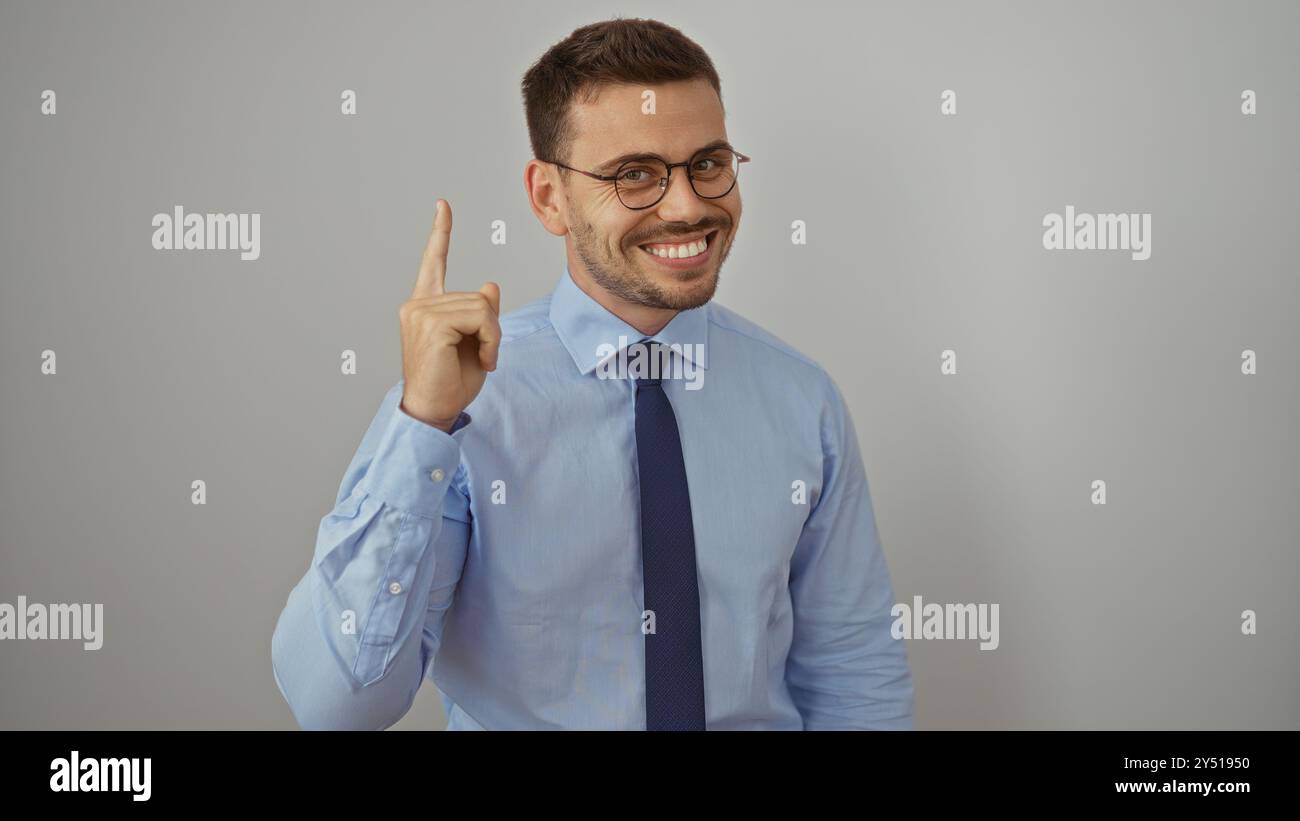 Handsome young hispanic man with a beard and glasses wearing a blue ...