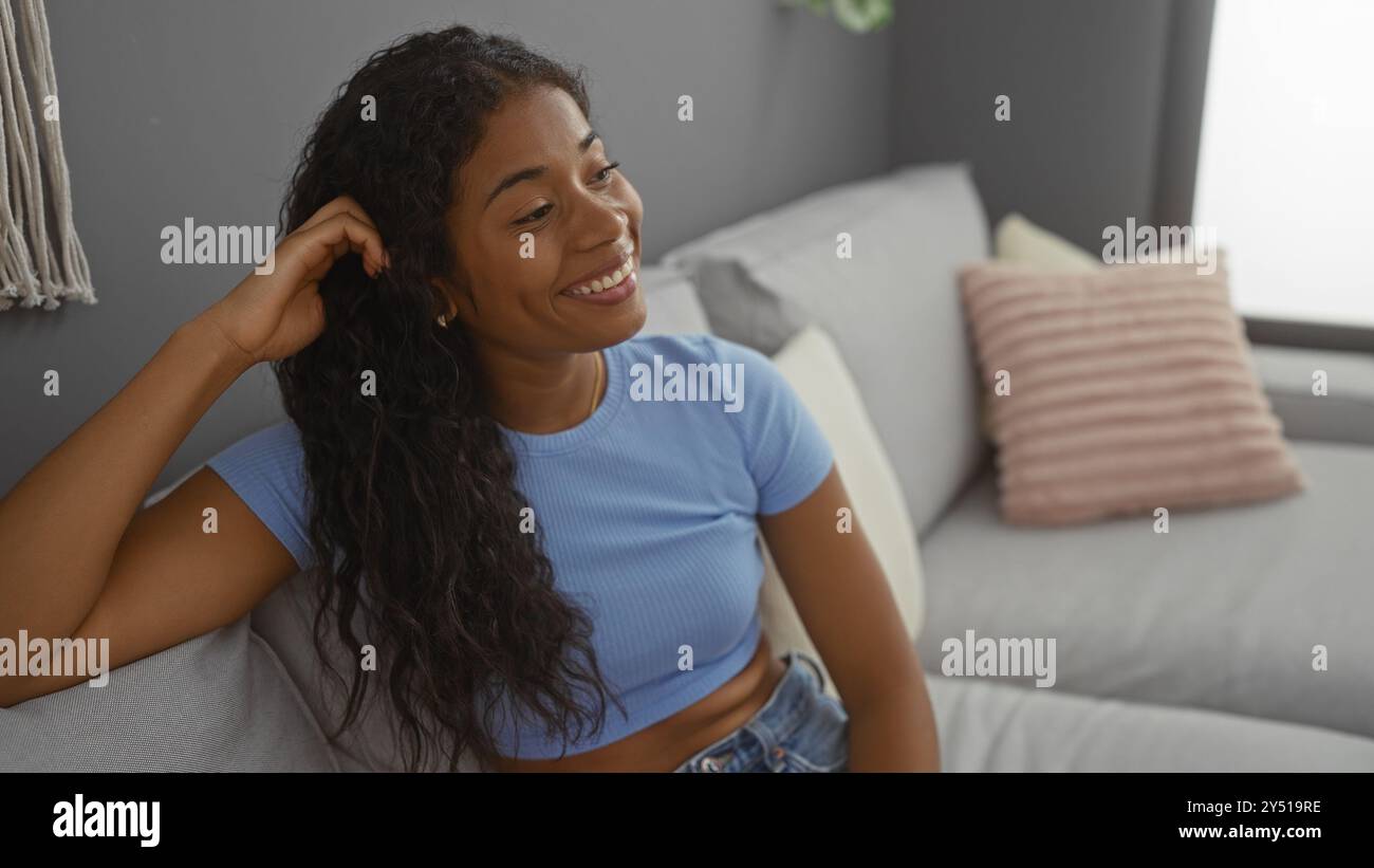 Beautiful woman smiling indoors in a cozy living room with stylish ...