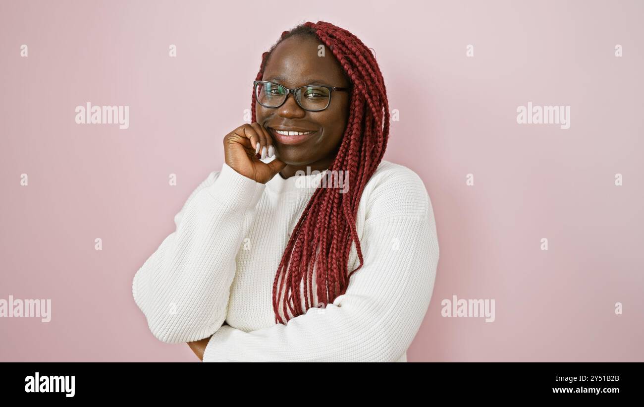 African american woman with braids smiling over an isolated pink ...