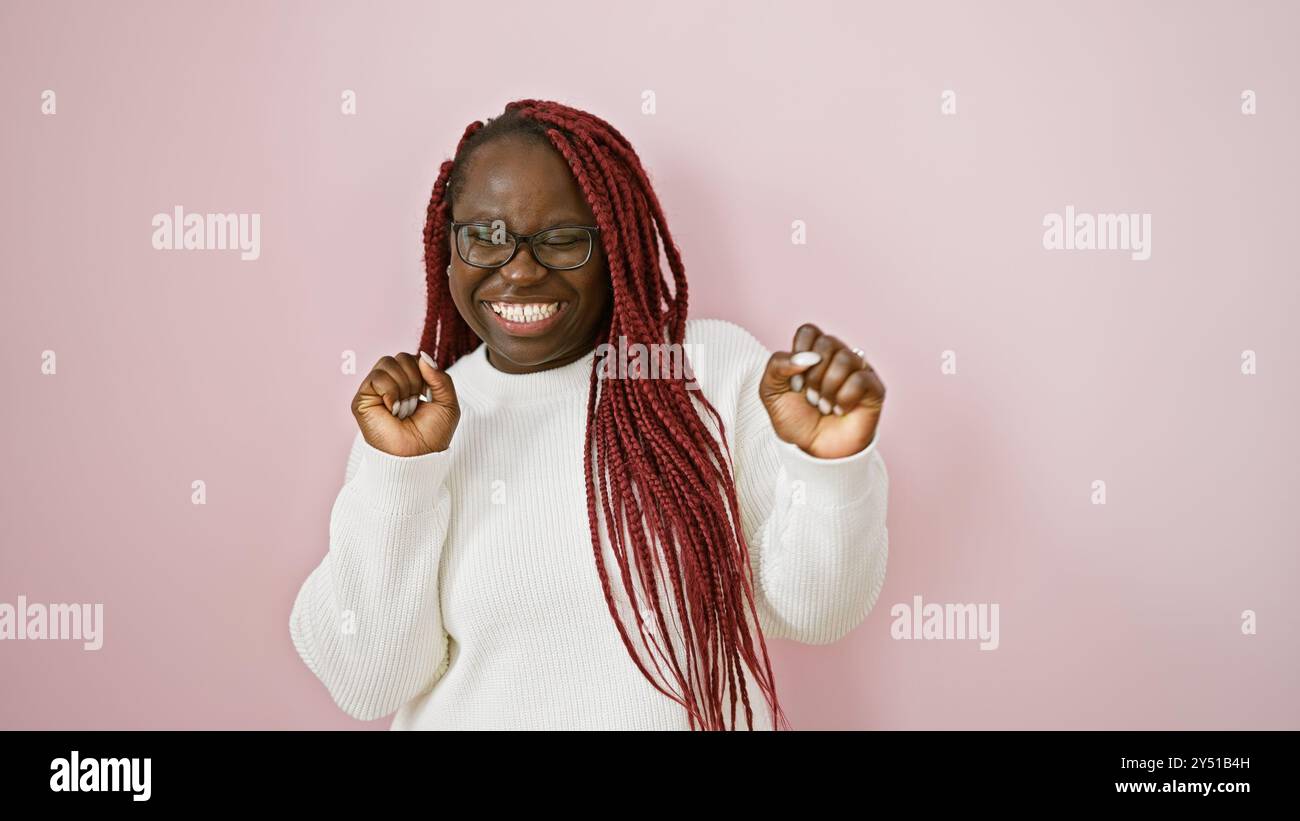 Joyful african woman with braids wearing glasses and white sweater ...