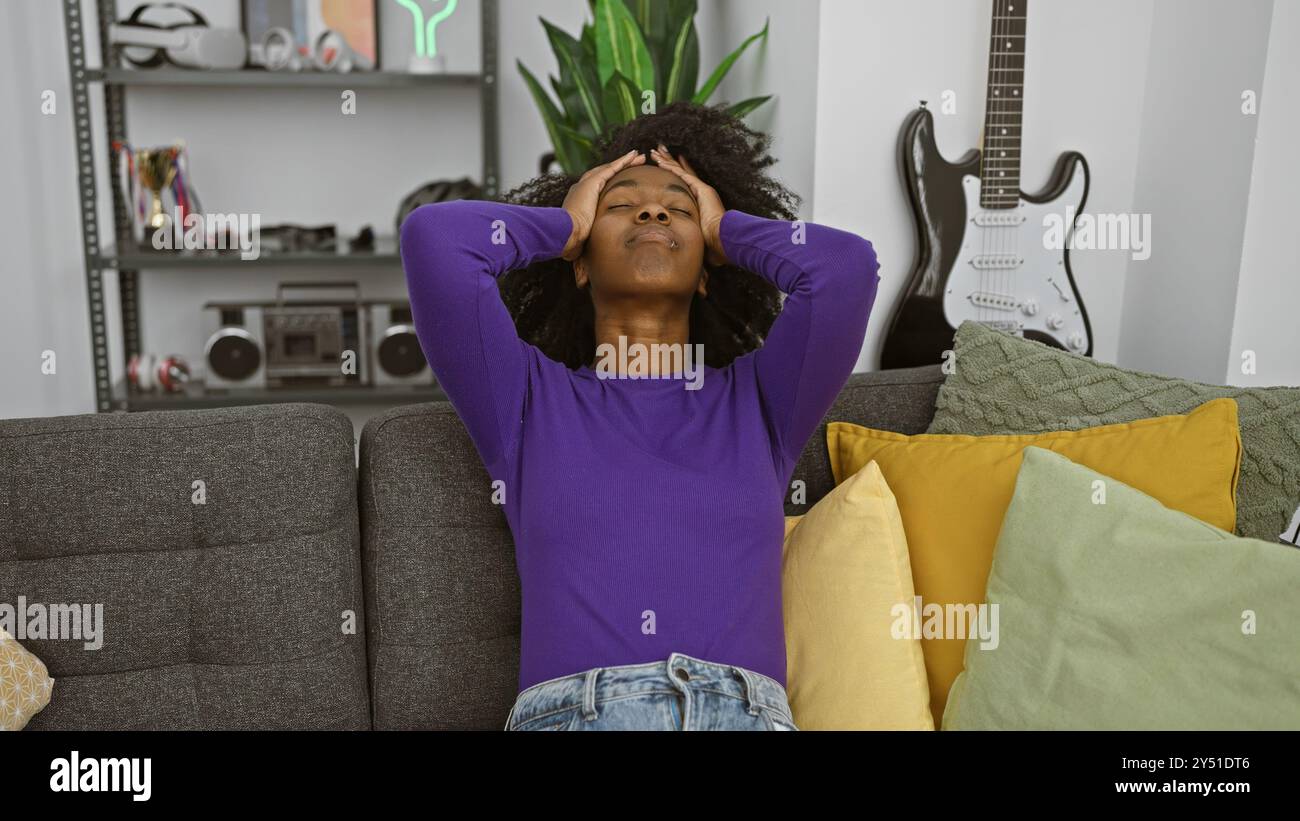 Relaxed african american woman sitting on couch at home with eyes ...