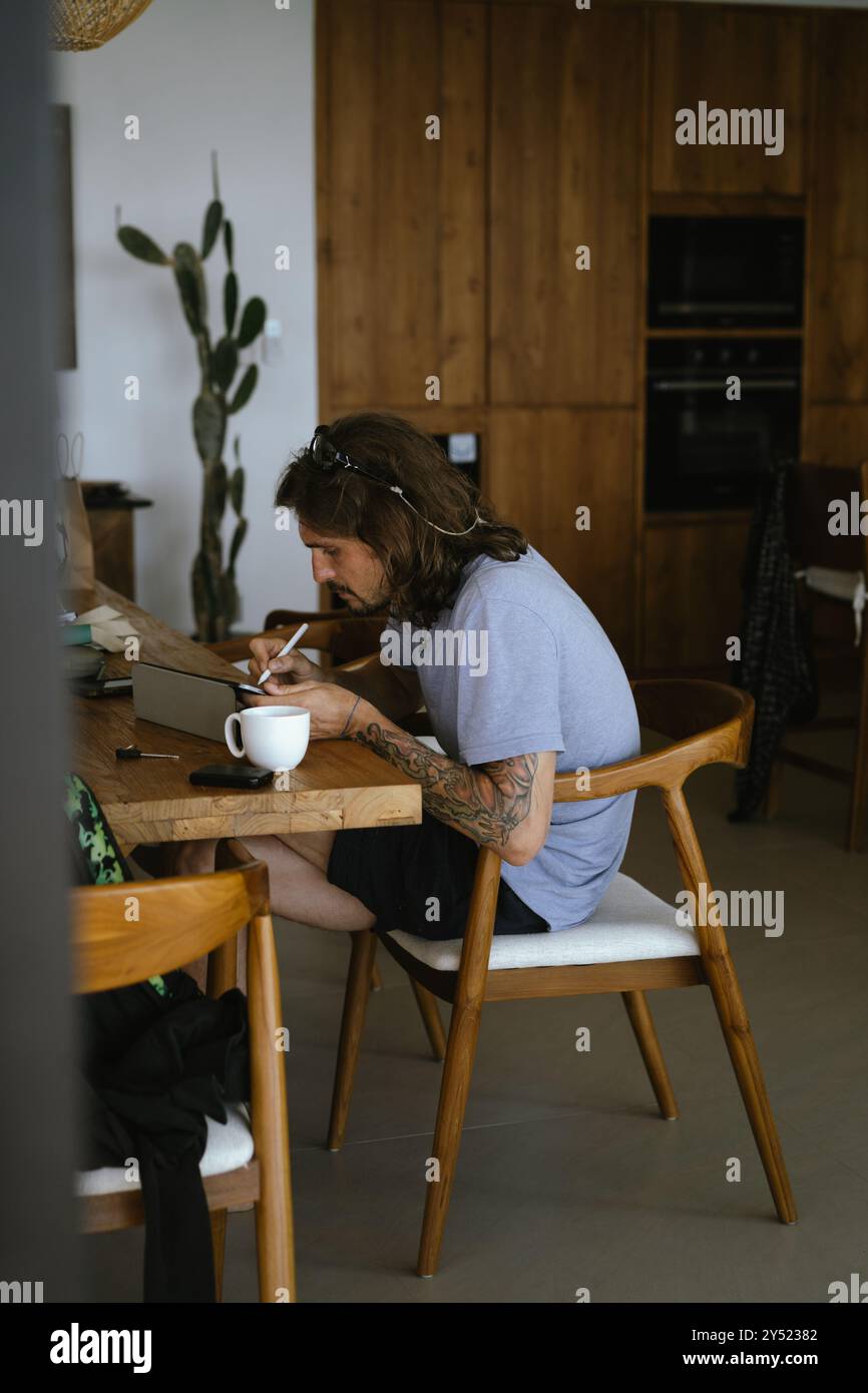 Man using tablet computer while working in office. Stock Photo