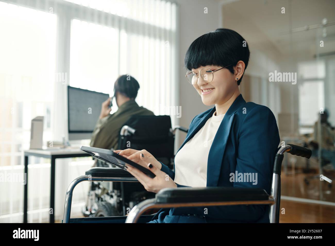 Woman With Disability Working On Tablet PC Stock Photo