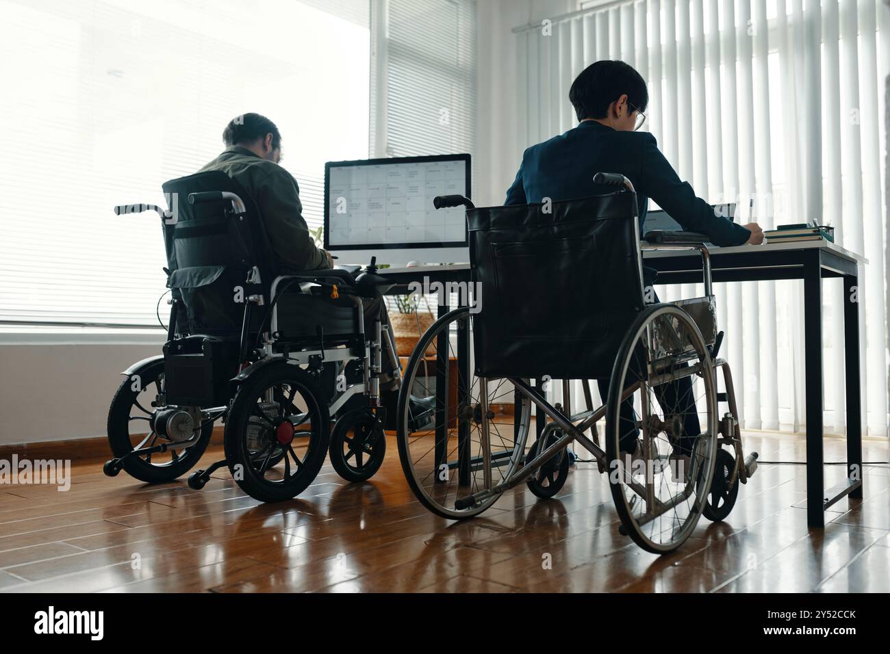 Colleagues With Disability Working On Computers Stock Photo