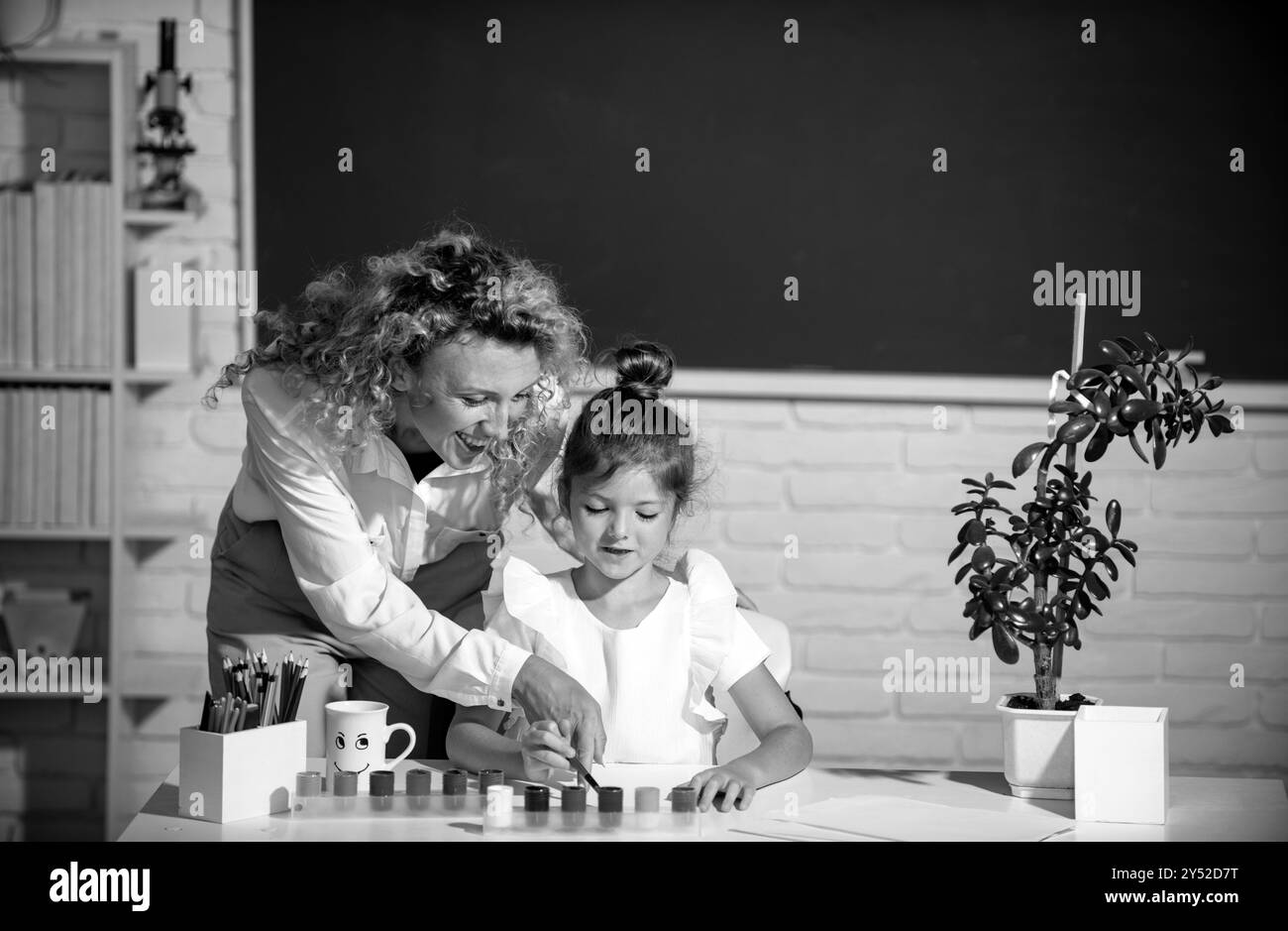 Schoolgirl with teacher Black and White Stock Photos & Images - Alamy