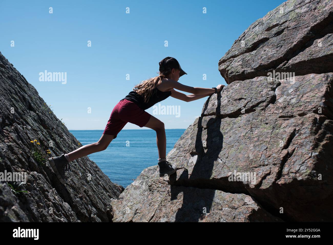 Slmbing Rocks girl climbing rocks bouldering in Skåne, Sweden Stock Photo - Alamy