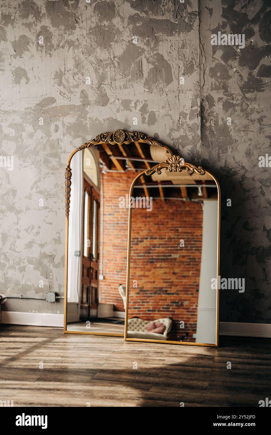 Two ornate mirrors reflect a rustic brick interior with textured wall ...