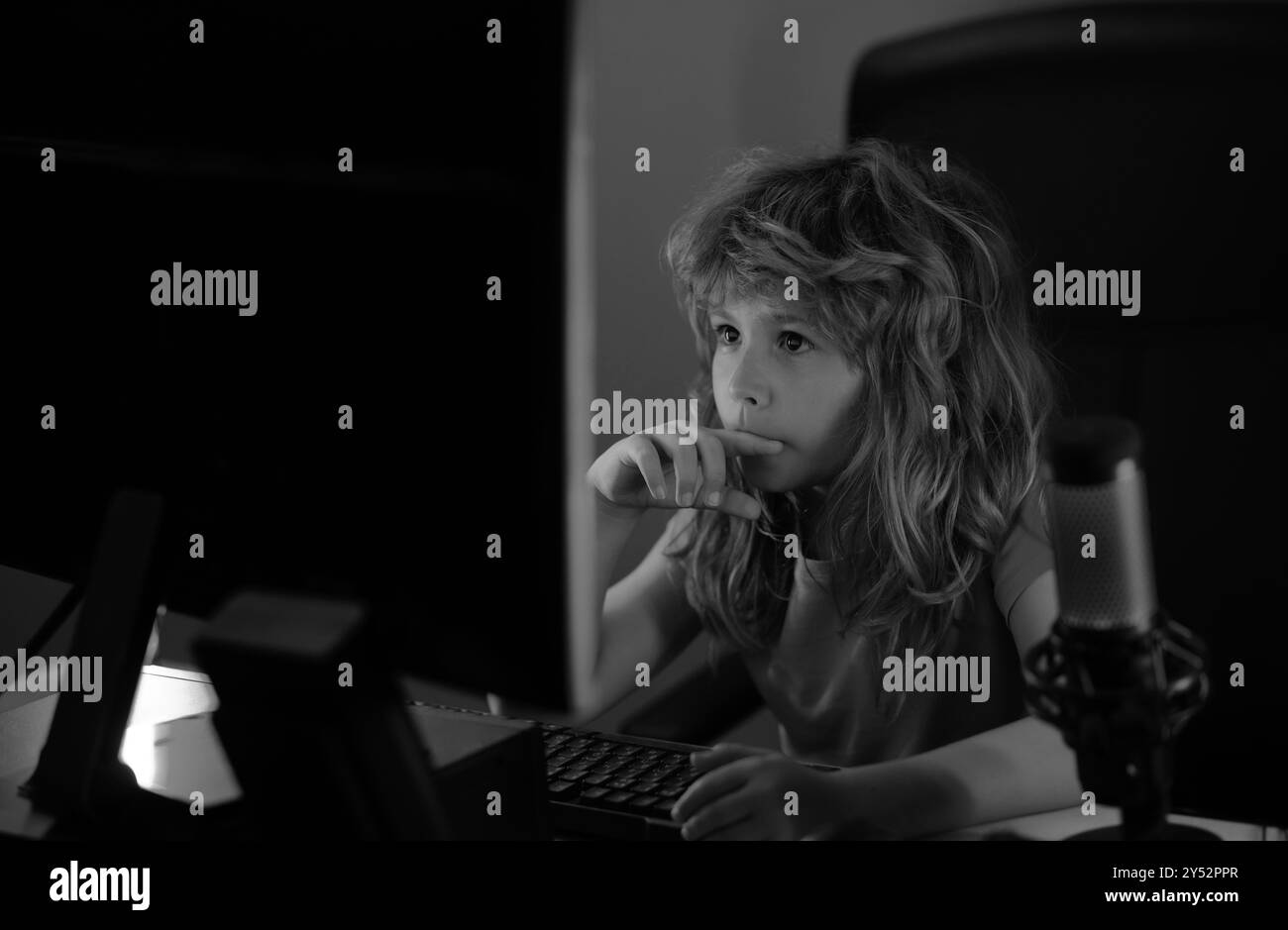 Little kid using desktop pc by night, child boy illuminated by the blue ...
