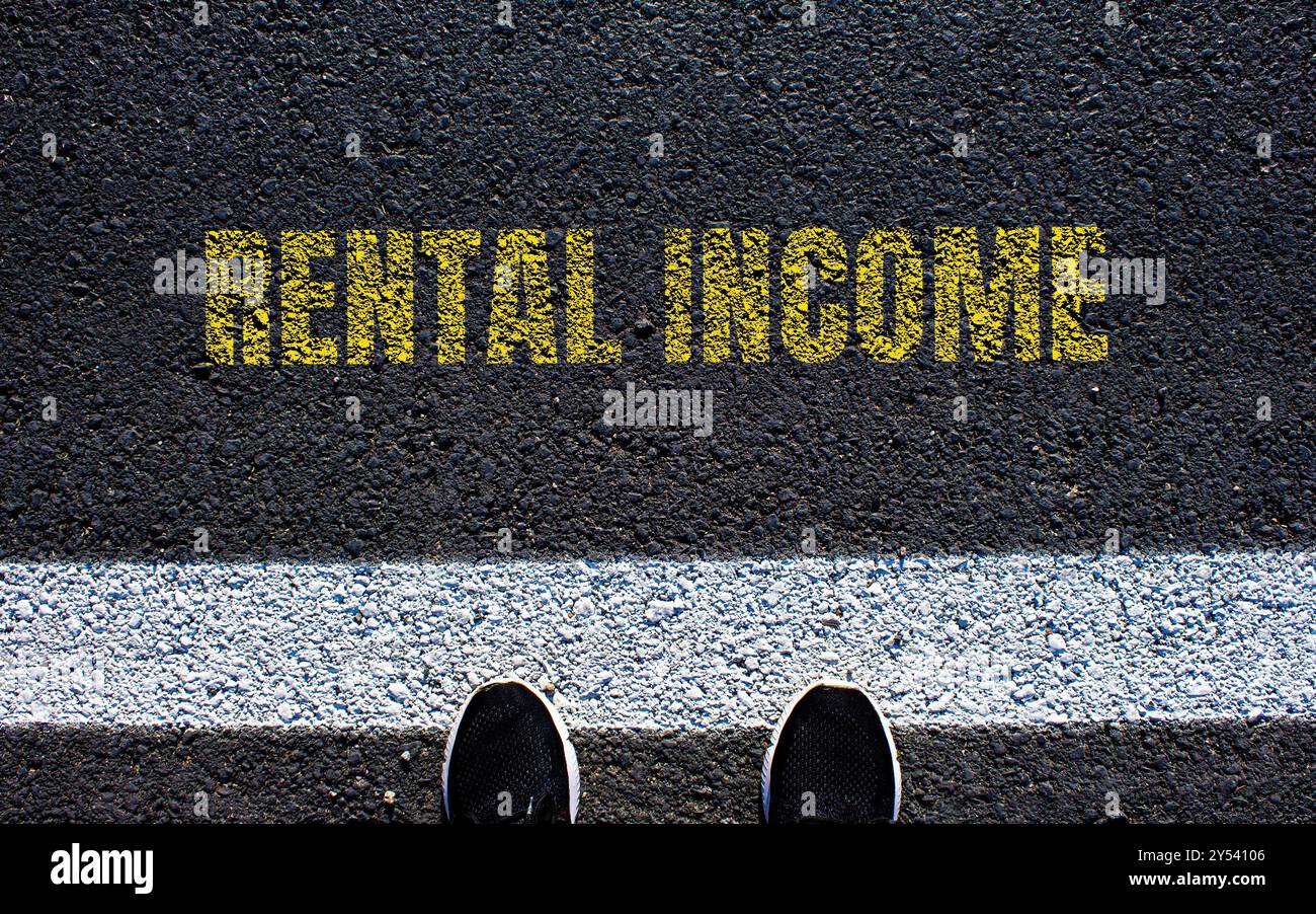 Rental income message written on asphalt road. Conceptual rental income ...