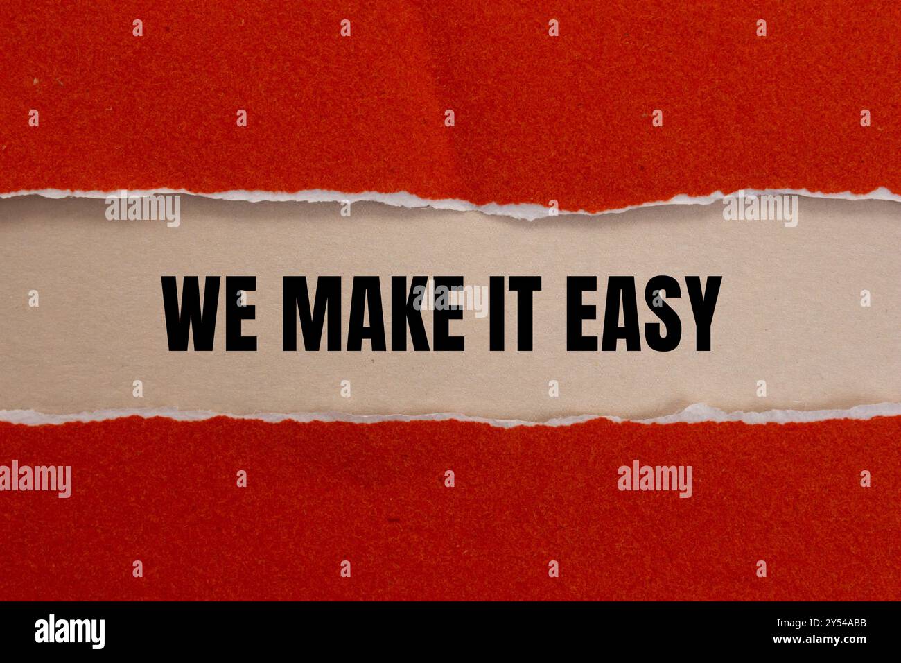We make it easy message written on ripped red torn paper with beige ...