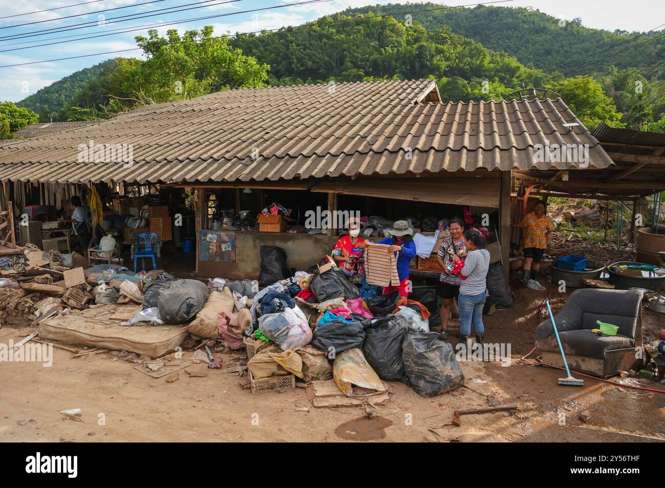 The inhabitants of a village in Mae Yao sub-district are seen checking ...