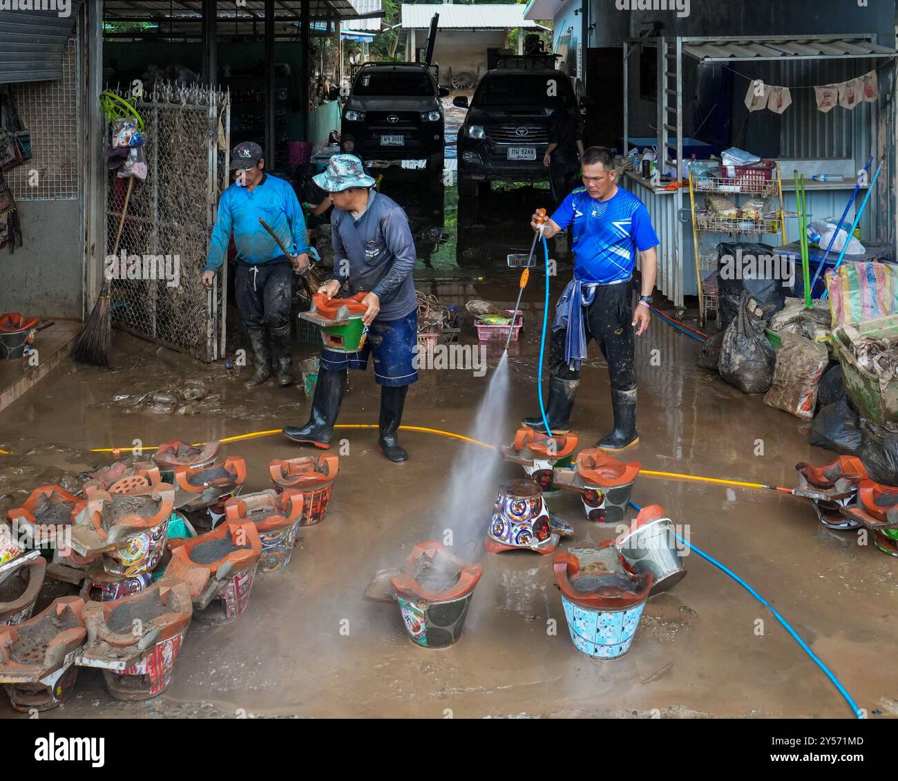 September 17, 2024, Chiang Rai, Thailand: Men are seen cleaning ...